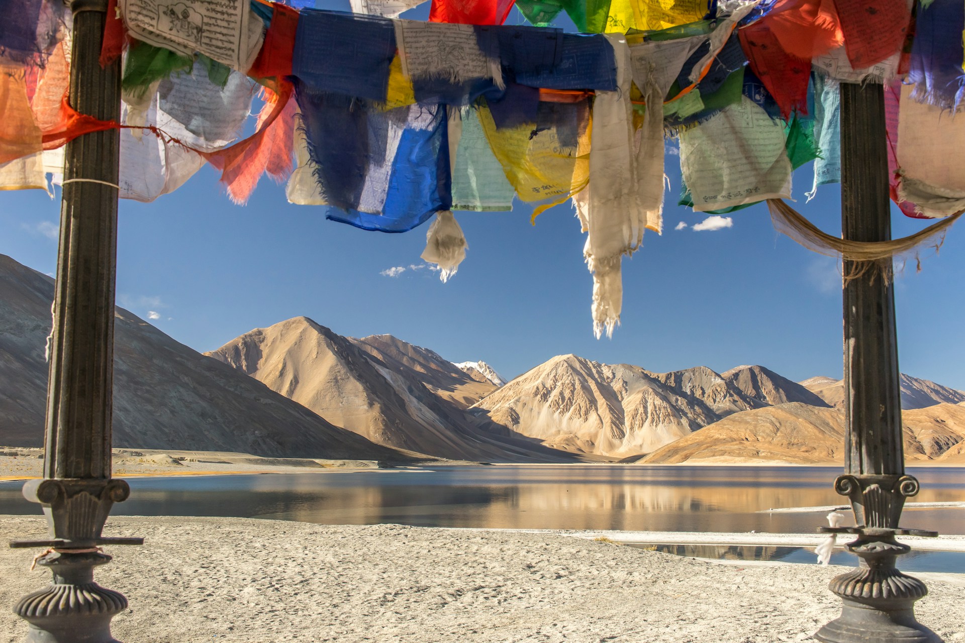 Hemis Monastery courtyard with prayer flags against a clear sky